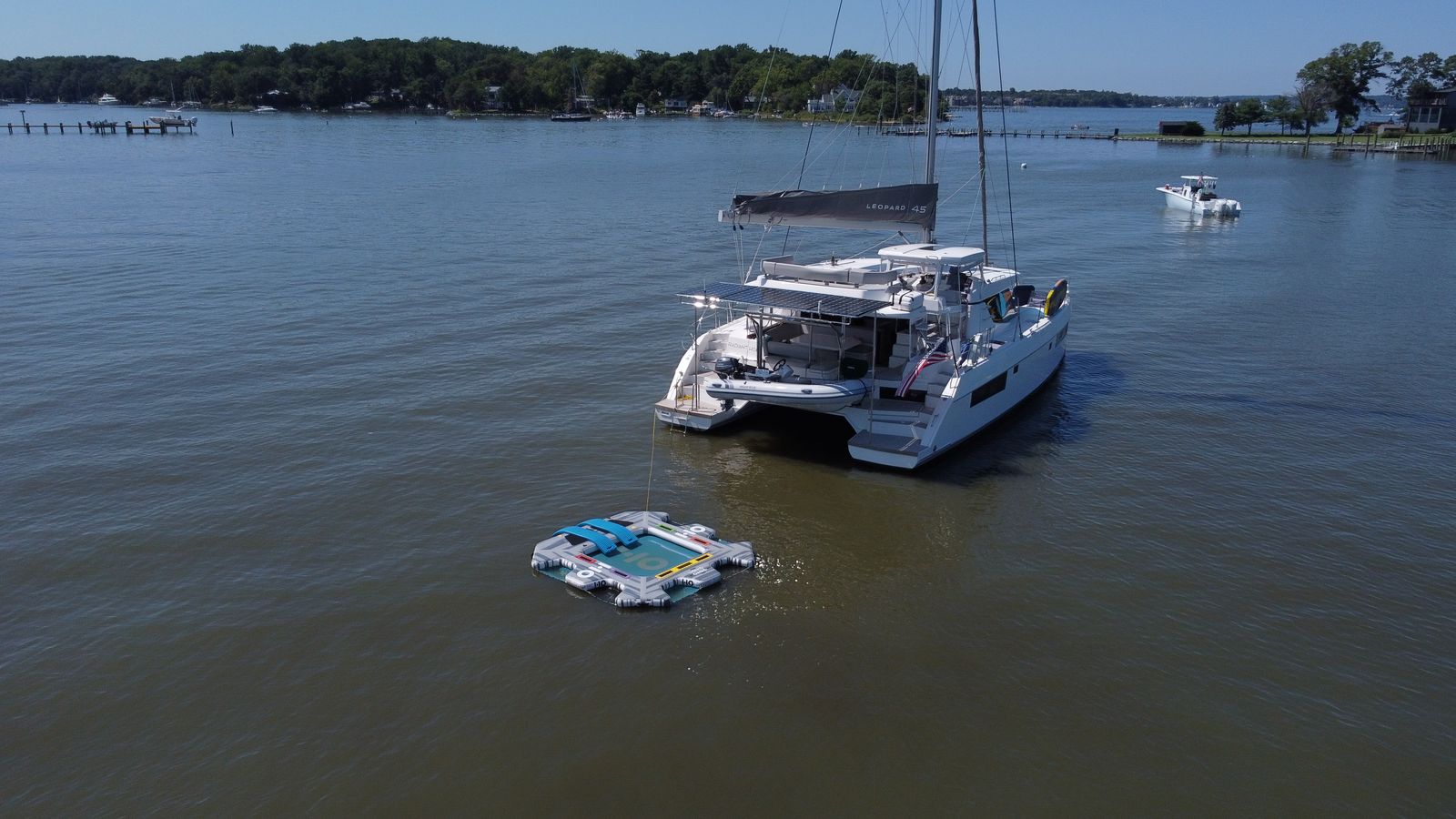 Aerial stern-quarter showing solar array, dinghy, and swim platforms
