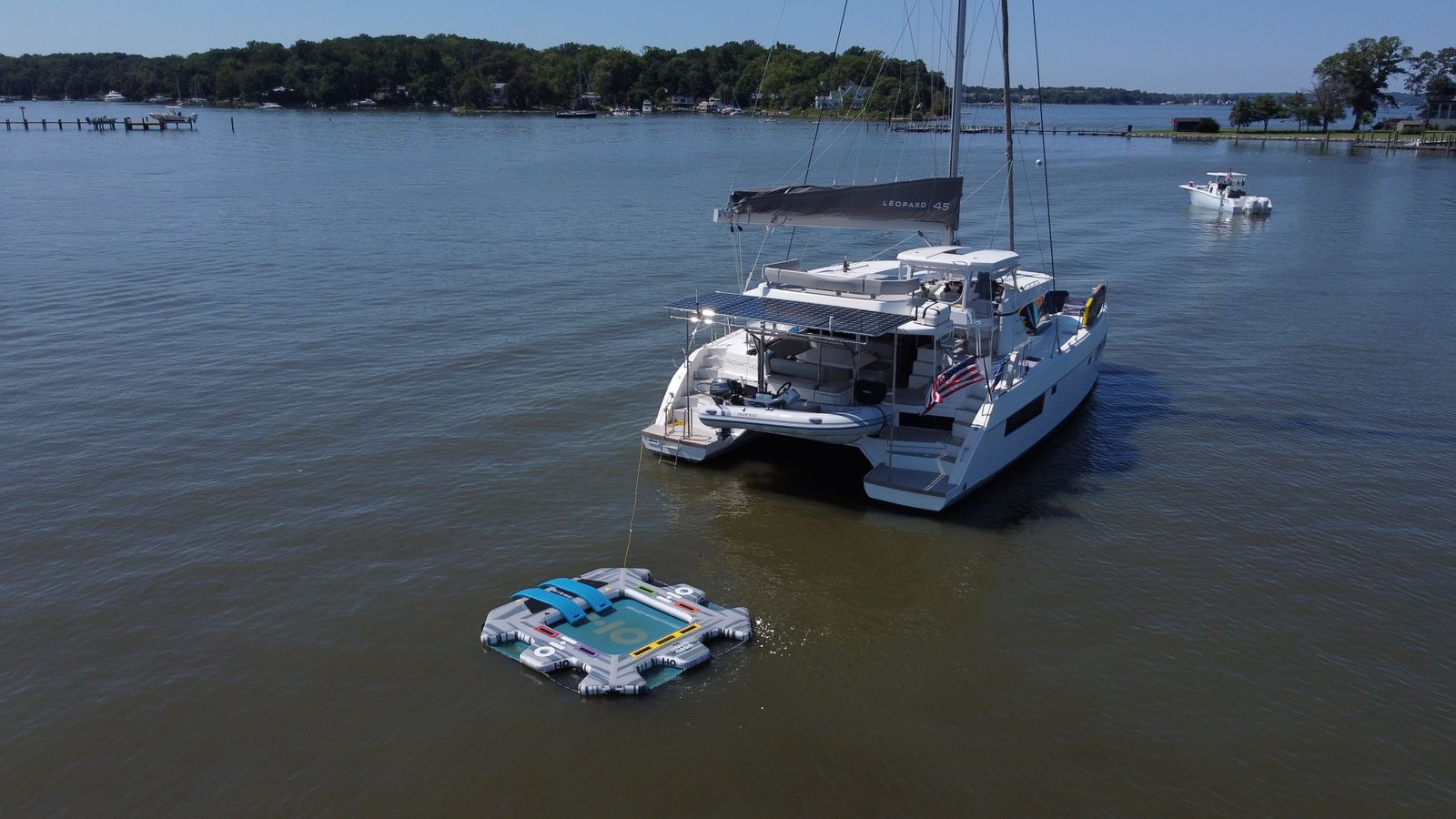 Aerial of coachroof lounge cushions, solar array, PlasDeck steps, and tender